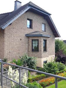 a brick house with windows and a fence at Kaisers Ferienhaus in Kaifenheim