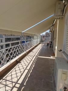 a balcony of a building with a view of a building at Acharnon Private Room in Athens