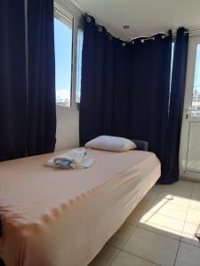 a bedroom with a large bed with blue curtains at Acharnon Private Room in Athens