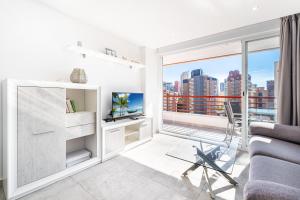 a living room with a couch and a tv at Piscis 10-8 Apartment Levante Beach in Benidorm