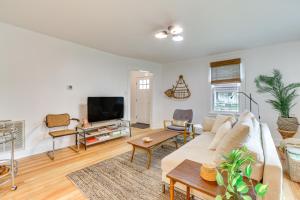 a living room with a couch and a tv at Danville Rental, Walk to Caesars Virginia Casino in Danville