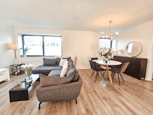 a living room with a couch and a table at Modernes Appartment im Grünen in Witten +4 photos