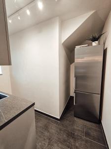 a kitchen with a stainless steel refrigerator in a room at Modernes Appartment im Grünen in Witten
