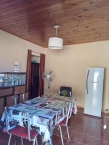 a kitchen with a table and a refrigerator at el sueño del pibe in San Antonio de Areco +4 photos