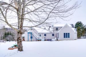 een wit huis met een boom in de sneeuw bij Colorful Milford Home on 7 Wooded Acres! in Milford