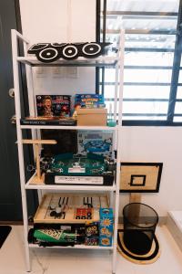 a shelf filled with toys and other items in a room at Hideout Airbnb in Pandi