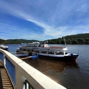 a boat is docked at a dock on the water at U Macháčků - Lipno in Lipno nad Vltavou