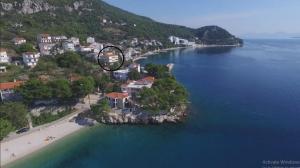 an aerial view of a house on an island in the water at Apartments and Rooms Katarina in Živogošće