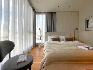 a large bedroom with a large bed and a table at Super Luxury Designer Sleeps 6 People in Thonglor in Bangkok