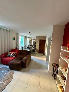 a living room with a couch and a table at Apartamento Oxe! Tô na Bahia in Salvador