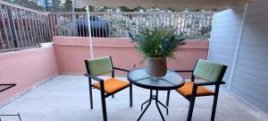 a table and two chairs and a vase on a patio at Avista apartments in Lygia