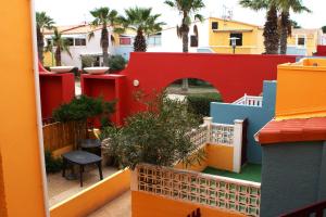 a view from the balcony of a colorful house at Résidence au soleil avec Piscine à 150m de la plage - Barcarès in Le Barcarès