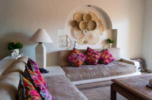 a living room with a couch and a hat on the wall at Velas Vallarta Ocean View in Puerto Vallarta