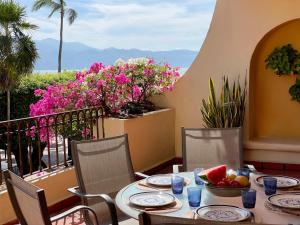 a table with a bowl of fruit on a balcony at Velas Vallarta Ocean View in Puerto Vallarta