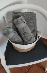 a white chair with a pile of blankets at Casa Rural La Tejeria in Villora