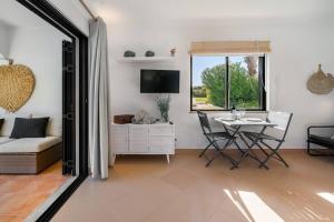 a living room with a table and a couch at Arribas Studio in Albufeira