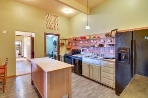 uma grande cozinha com paredes amarelas e pisos de madeira em Cozy Ridgway Vacation Rental Hike, Ski and Explore! em Ridgway