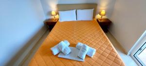 a bedroom with a bed with two pillows on it at Avista apartments in Lygia +53 photos