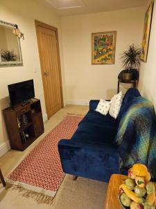uma sala de estar com um sofá azul e uma mesa em The Arches em Brough