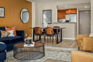a living room with a couch and a table at Urban Gallery Loft - King Bed - Larimer Square in Denver
