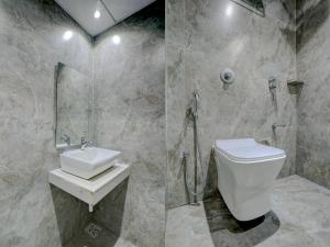 ein Bad mit einer Dusche, einem WC und einem Waschbecken in der Unterkunft Gorrionn Hotel 10 Mins From Airport in Mumbai