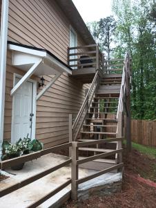 a wooden staircase leading up to a house at Luxury Suite in Austell