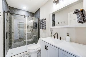 a bathroom with a shower and a toilet and a sink at Historic Hollister Home Shop, Dine and Drink Nearby in Hollister +24 photos