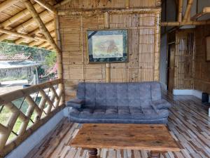 a blue couch sitting on a porch with a table at La Tebaida Posada Rural in Ubaque