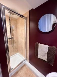 a bathroom with a shower and a glass shower stall at Entire ground floor town flat - Fully equipped and stunning. in Shrewsbury