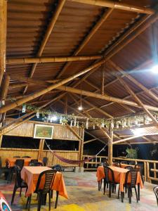 a dining room with tables and chairs in a building at La Tebaida Posada Rural in Ubaque