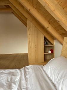 a bedroom with a white bed and a book shelf at Nova Drina in Ljubovija