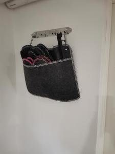 a black purse hanging on a wall at Vila Ösmo in Ösmo