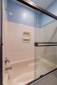 a shower with a glass door in a bathroom at Downtown Sophistication/ Two Bedroom / Two Bath in Louisville