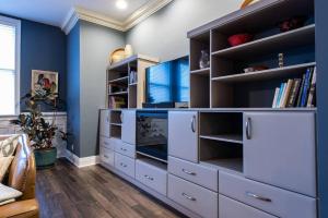 a large bedroom with blue walls and white shelves at Downtown Sophistication/ Two Bedroom / Two Bath in Louisville