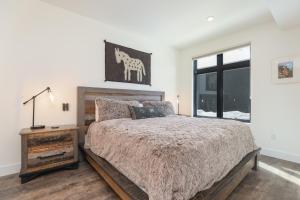 a bedroom with a large bed and a window at Après Shores Condo: Upscale Riverfront Retreat in Silverthorne
