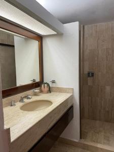 a bathroom with a sink and a mirror at Amazing Ocean View in Puerto Vallarta