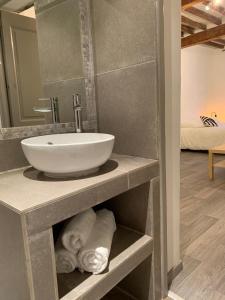 baño con lavabo y toallas en un estante en Studio Charmant au Cœur de Carpentras, en Carpentras