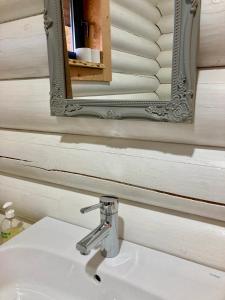 a bathroom with a sink and a mirror at Mountain Log Cabin O Lobo in Cabeceiras de Basto +113 photos