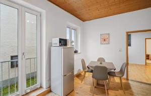 a dining room with a table and chairs and a kitchen at Apartment im Pfaffenwinkel Nähe Alpen und München in Peiting