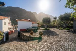 a car parked in a driveway with a stone road at Casa do Terreiro by An Island Apart in São Vicente