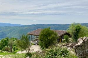 a house on top of a hill with a view at Mountain Log Cabin O Lobo in Cabeceiras de Basto