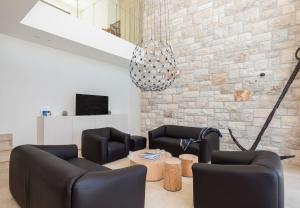 a living room with couches and a brick wall at Villa Stara in Selca +47 photos
