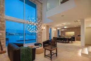a living room with a chandelier and a dining room at Villa Stara in Selca