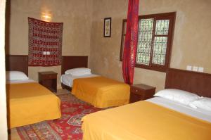 a room with two beds and two windows at Auberge Amellagou in Amellago