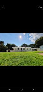 a view of a building in a field of grass at Sandy Toes Hoburne Devon Bay Holiday Park. in Paignton