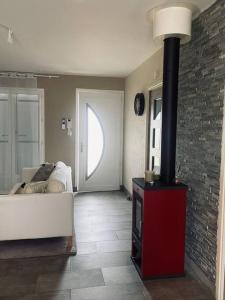 a living room with a white couch and a fireplace at Petit nid douillet mitoyen à Auterive in Auterive +9 photos