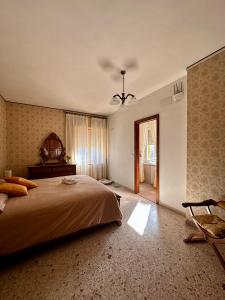 a bedroom with a bed and a chair in it at Affittacamere La Dimora dei Nonni in Cascia