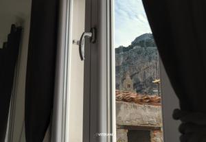 a window with a view of a mountain at Veterani Holidays Cefalù in Cefalù
