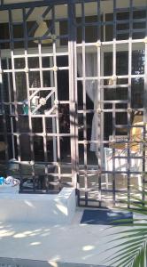 a person is looking out the window of a house at Casa familiar in Batey La Altagracia