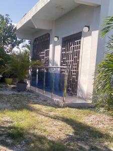 a front porch of a house with a gate at Casa familiar in Batey La Altagracia